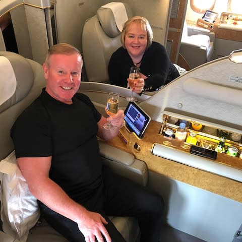 Neil Evans and Lorraine Campbell share a toast on a first-class flight to Dubai, where they were moving to start a new life
