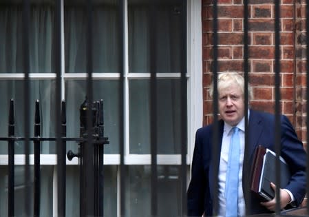 Britain's PM Boris Johnson leaves Downing Street from the rear entrance door, in London