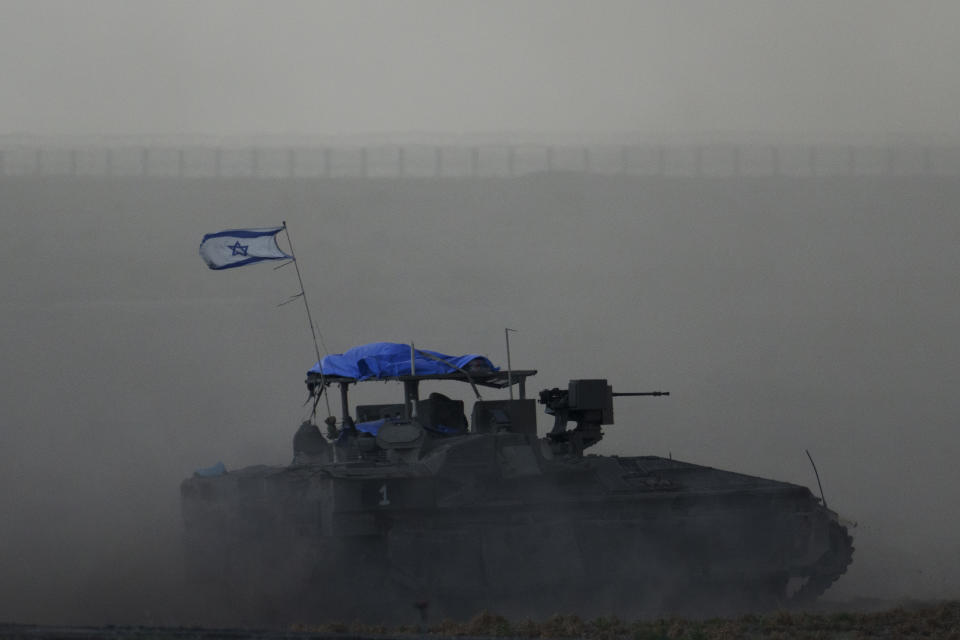 Israeli armored vehicle moves near the Israeli-Gaza border, as seen from southern Israel, Thursday, Feb. 15, 2024. (AP Photo/Leo Correa)