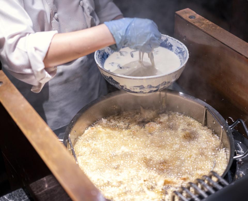 a person frying tempura