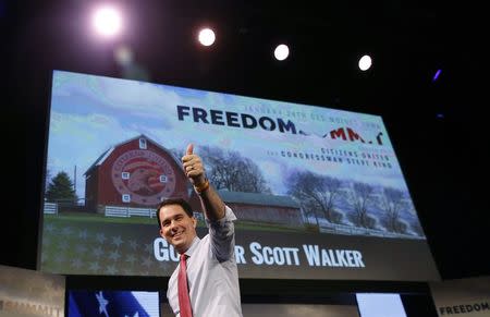 Wisconsin Governor Scott Walker walks off the stage after speaking at the Freedom Summit in Des Moines, Iowa, January 24, 2015. REUTERS/Jim Young