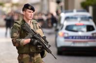 <p>An armed French soldier stands at the site where a car slammed into soldiers in Levallois-Perret, outside Paris, on August 9, 2017. (Photo: Stephane de Sakutin/AFP/Getty Images) </p>