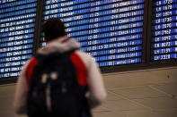 A man looks at the flight schedule on a display board, showing several flights canceled (annulliert), at Munich Airport, Germany, Wednesday, Jan. 17, 2024. Heavy snowfalls and freezing rain across Germany Wednesday led to the cancellation of hundreds of flights and trains, crashes on icy roads, and school closures. (Matthias Balk/dpa via AP)
