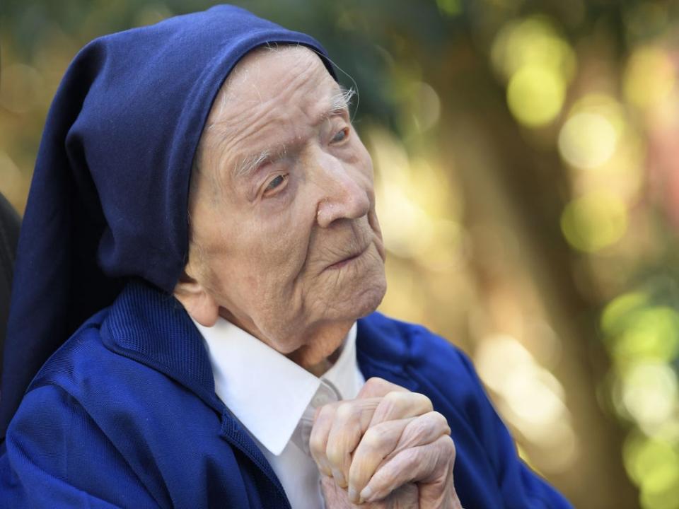 Sister Andre, Lucile Randon in the registry of birth, the eldest French and European citizen, prays in a wheelchair, on the eve of her 117th birthday  (AFP via Getty Images)