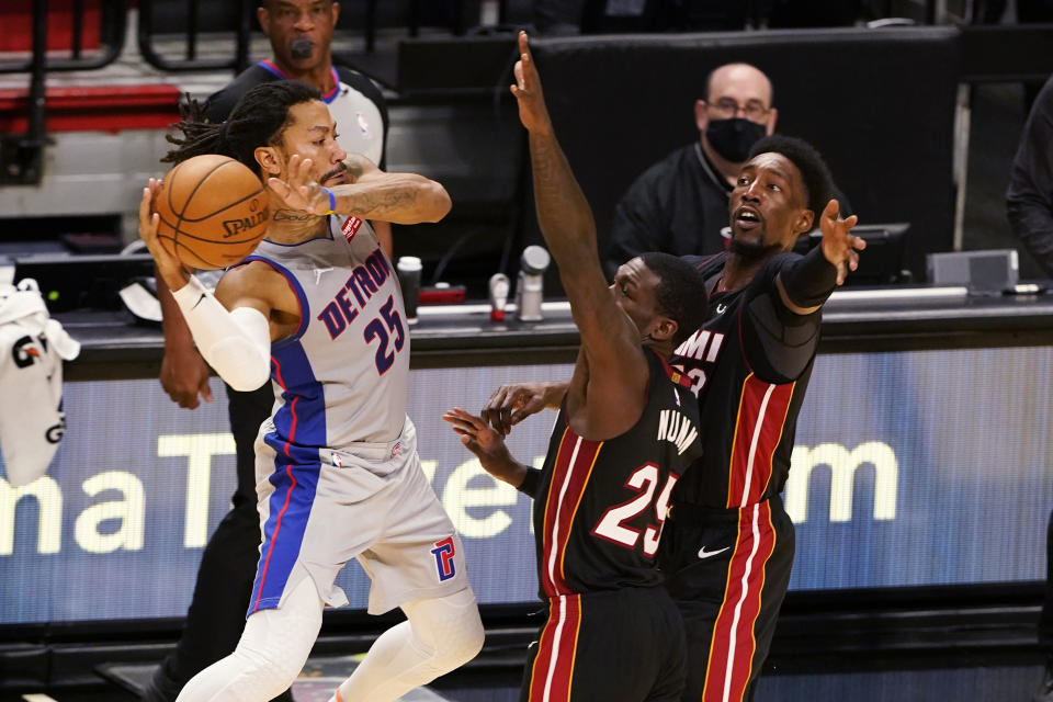 Miami Heat guard Kendrick Nunn (25) and center Bam Adebayo (13) attempt to block a pass by Detroit Pistons guard Derrick Rose (25) during the second half of an NBA basketball game, Monday, Jan. 18, 2021, in Miami. (AP Photo/Marta Lavandier)