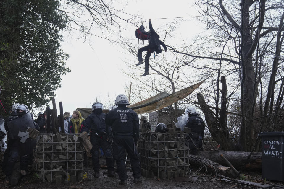 Police officers enters a camp of climate activists at the village Luetzerath near Erkelenz, Germany, Wednesday, Jan. 11, 2023.The village of Luetzerath is occupied by climate activists fighting against the demolishing of the village to expand the Garzweiler lignite coal mine near the Dutch border. (AP Photo/Michael Probst)