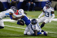Indianapolis Colts wide receiver T.Y. Hilton (13) is tackled by Tennessee Titans defensive back Chris Jackson (35) and strong safety Amani Hooker (37) in the second half of an NFL football game in Indianapolis, Sunday, Nov. 29, 2020. (AP Photo/Darron Cummings)