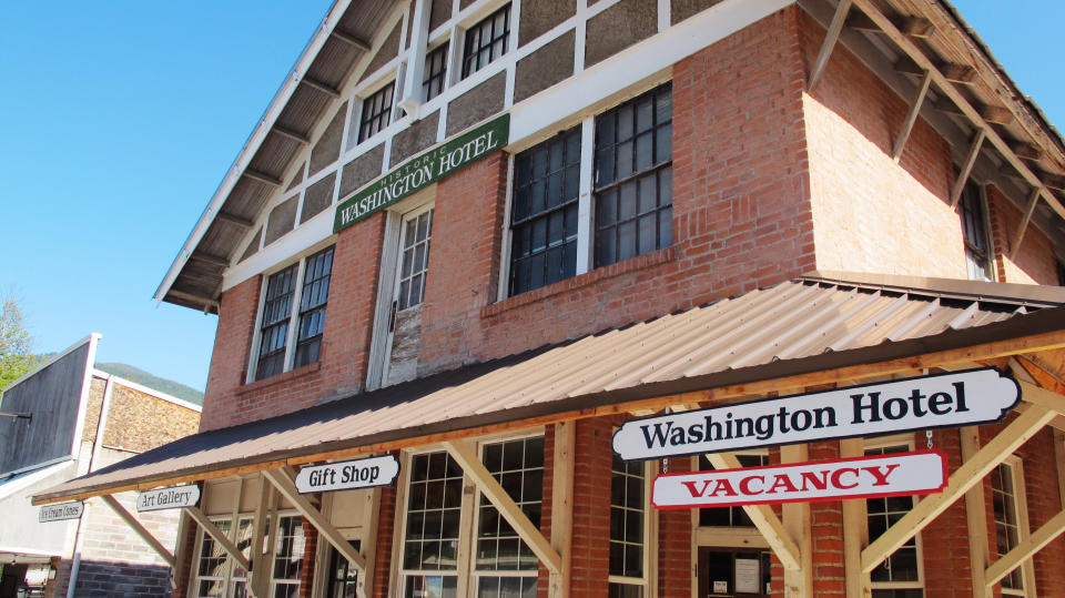 This Wednesday, July 31, 2019 photo shows The Washington Hotel which is one of a handful of operating businesses in downtown Metaline Falls, Wash. . The tiny town suffered a blow when a nearby mine closed, at a cost of some 200 good-paying jobs. The Pend Oreille Mine near Metaline Falls has closed, costing the rural community some 200 good-paying jobs. (AP Photo/Nicholas K. Geranios)