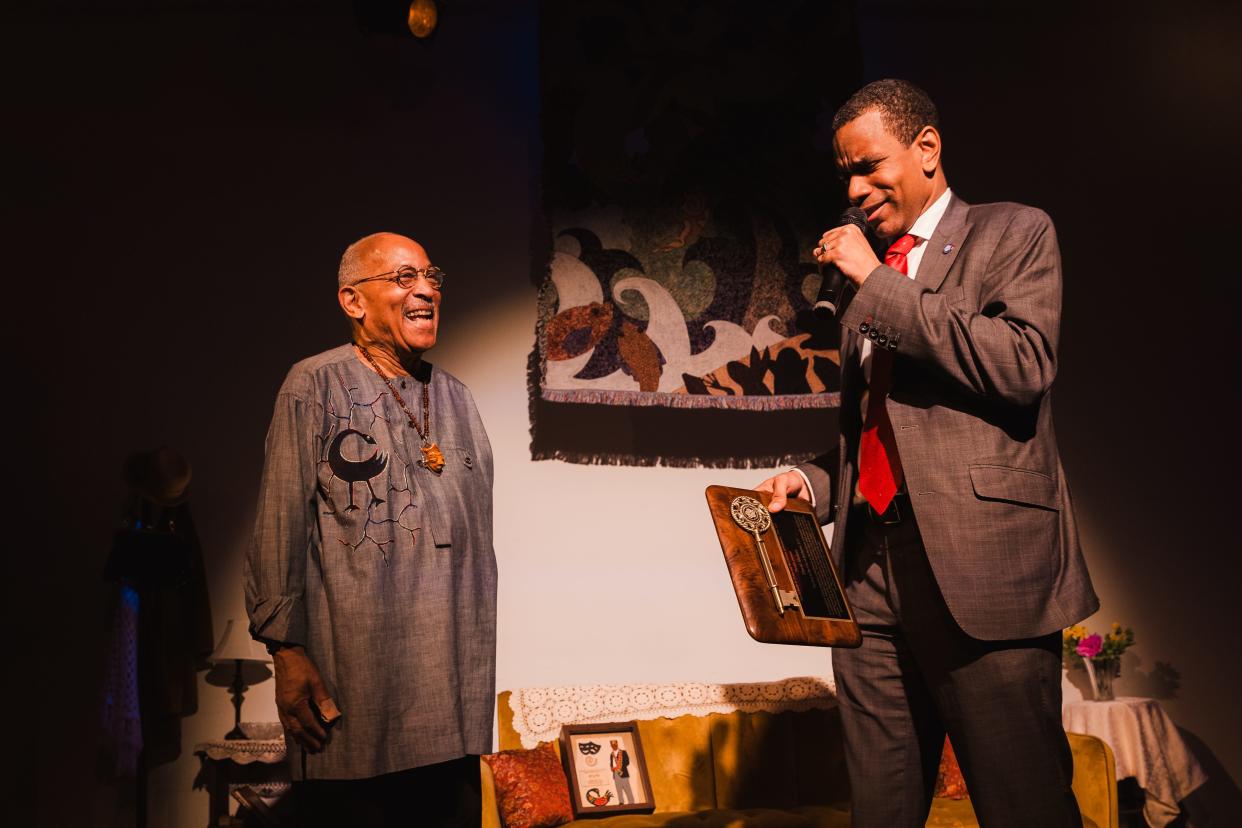 (Right) Mayor Malik Evans honors David Shakes with a key to the city on Thursday night at the Avenue Blackbox Thearter.