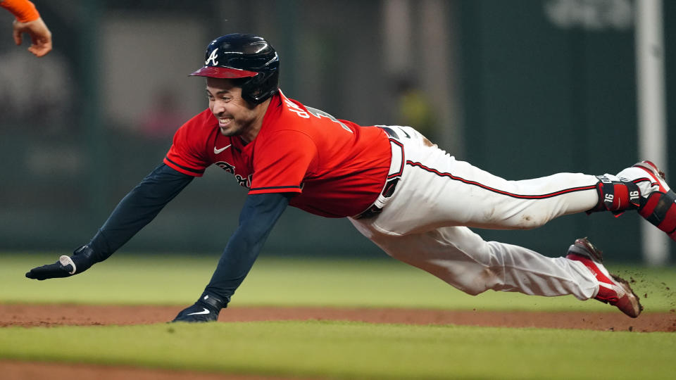 Atlanta Braves' Travis d'Arnaud slides into second base with a double in the third Inning of a baseball game against the Houston Astros Friday, Aug. 19, 2022, in Atlanta. (AP Photo/John Bazemore)