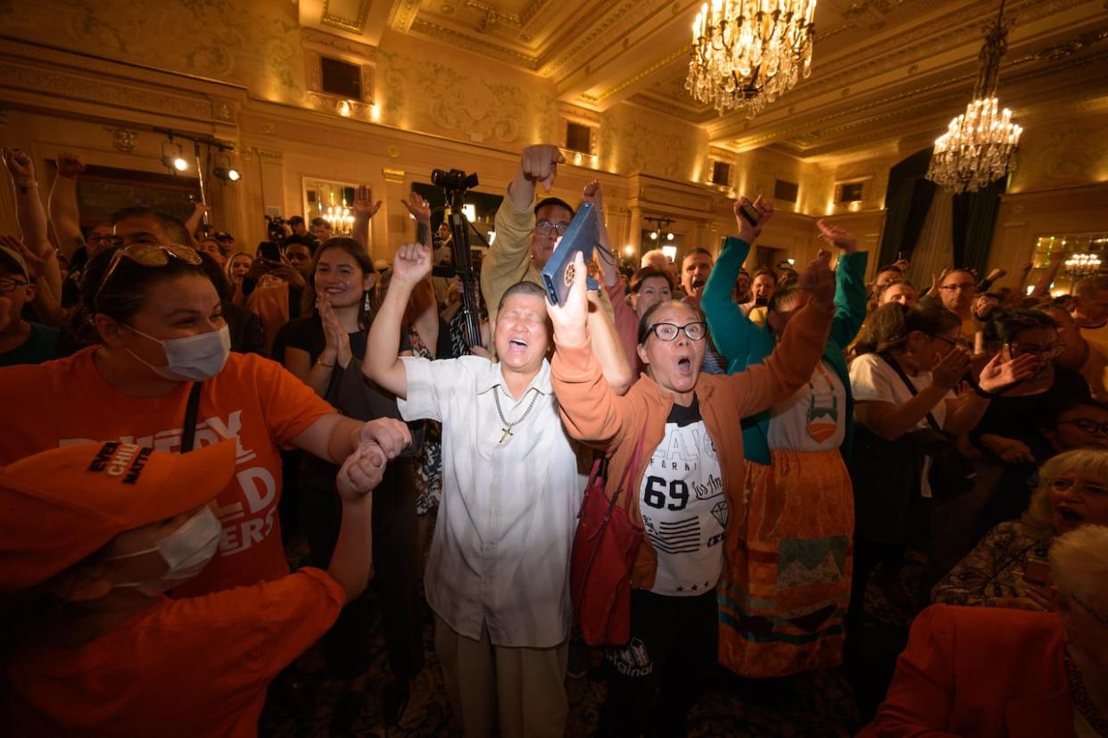 Manitoba NDP supporters cheer at the party's election headquarters at the Fort Garry Hotel in downtown Winnipeg on Tuesday. (James Turner/CBC - image credit)