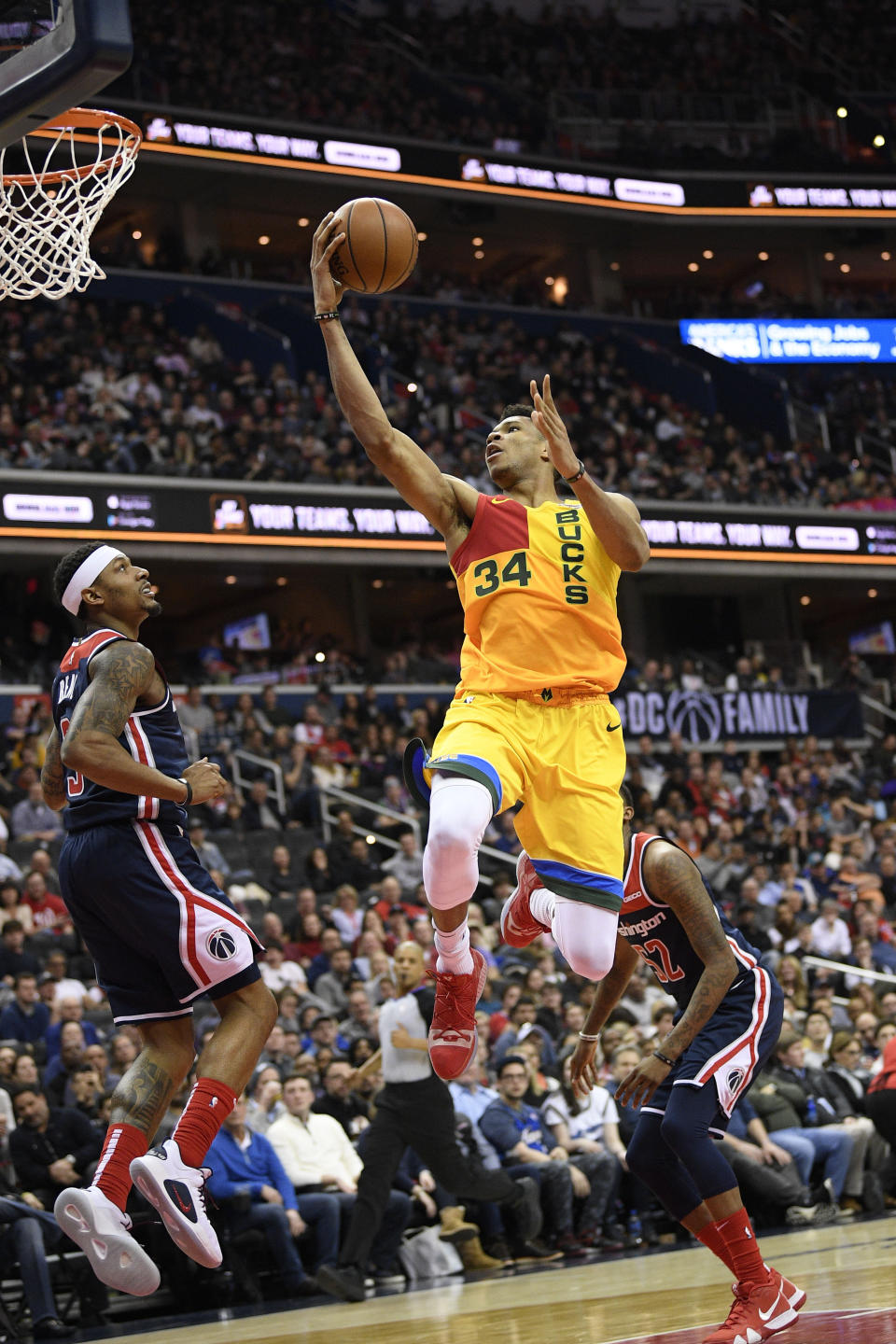 Milwaukee Bucks forward Giannis Antetokounmpo (34) goes to the basket against Washington Wizards guard Bradley Beal, left, and guard Jordan McRae (52) during the second half of an NBA basketball game, Saturday, Feb. 2, 2019, in Washington. Beal was called for a foul on the play. The Bucks won 131-115. (AP Photo/Nick Wass)