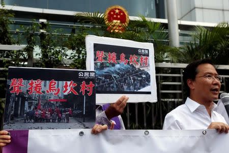 Protesters demonstrate with placards which read "Support Wukan village" outside China Liaison Office in Hong Kong, China September 14, 2016. REUTERS/Bobby Yip