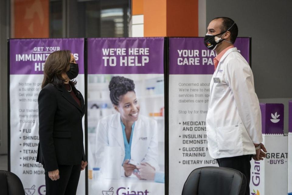 U.S. Vice President Kamala Harris speaks with pharmacist Samir Balile during a visit to the pharmacy of a Giant Foods grocery store to promote the Biden Administrations Federal Retail Pharmacy Program for COVID-19 vaccination on February 25, 2021 in Washington, DC. (Photo by Drew Angerer/Getty Images)