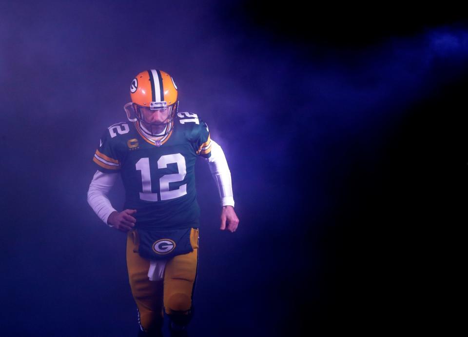 Green Bay Packers quarterback Aaron Rodgers (12) runs out on to the field as he is announced against the Detroit Lions during their football game Sunday, Jan. 8, 2023, at Lambeau Field in Green Bay, Wis.