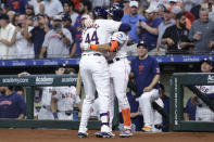 Houston Astros' Yordan Alvarez (44) and Jeremy Pena, right, hug after a solo home run by Alvarez against the Los Angeles Angels during the first inning of a baseball game Tuesday, May 21, 2024, in Houston. (AP Photo/Michael Wyke)