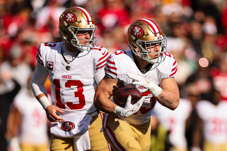 LANDOVER, MD - DECEMBER 31: Brock Purdy #13 (L) of the San Francisco 49ers hands the ball off to Christian McCaffrey #23 during the first half of the game against the Washington Commanders at FedExField on December 31, 2023 in Landover, Maryland. (Photo by Scott Taetsch/Getty Images)