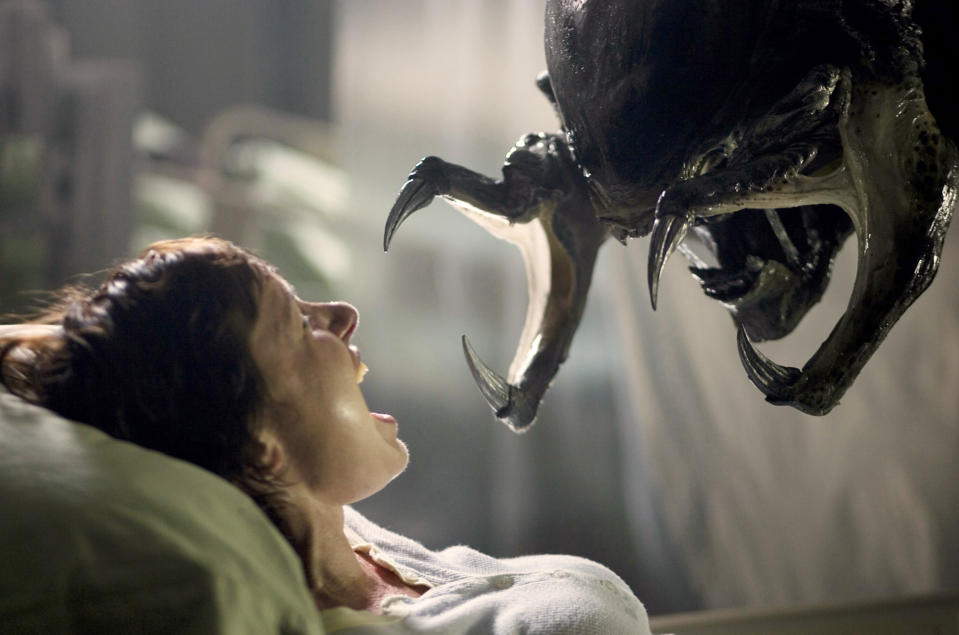 Predator about to attack a woman in "Aliens vs. Predator - Requiem"