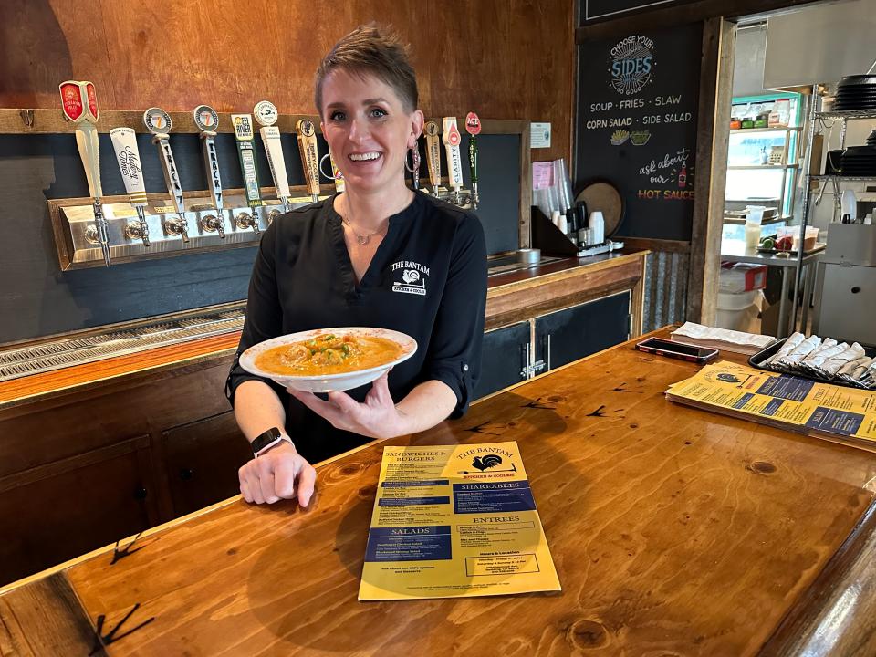 Kate Wood, owner of The Bantam Kitchen & Cooler in east Redding, displays a plate of the popular shrimp and grits.