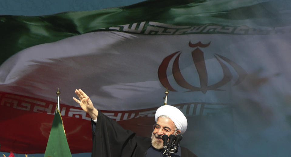 Iranian President Hassan Rouhani waves to the crowd as he arrives to deliver his speech during an annual rally commemorating anniversary of the 1979 Islamic revolution, at the Azadi, 'Freedom' Square. in Tehran, Iran, Tuesday, Feb. 11, 2014. Rouhani on Tuesday called for "fair and constructive" nuclear talks with world powers as the nation marked the anniversary of the 1979 Islamic revolution with massive rallies, complete with anti-American and anti-Israeli chants. Tuesday marks the 35th anniversary of the revolution that toppled the pro-U.S. Shah Mohammad Reza Pahlavi and brought Islamists to power. (AP Photo/Vahid Salemi)