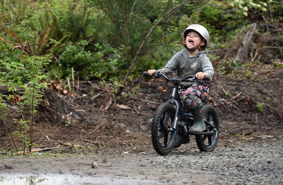 Ember Gautschi, 6, races her bike back-and-forth through puddles at the Port Gamble Ride Park.