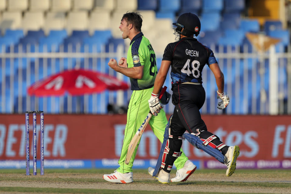 FILE - Ireland's Curtis Campher, left, celebrates after taking the wicket of Namibia's Zane Green, right, during the Cricket Twenty20 World Cup first round match between Namibia and Ireland in Sharjah, UAE, Friday, Oct. 22, 2021. Campher top scored with 72 runs off 32 balls in Ireland's six wicket win over Scotland in their T20 World Cup game in Hobart Australia, Wednesday, Oct.19, 2022. (AP Photo/Aijaz Rahi,File)