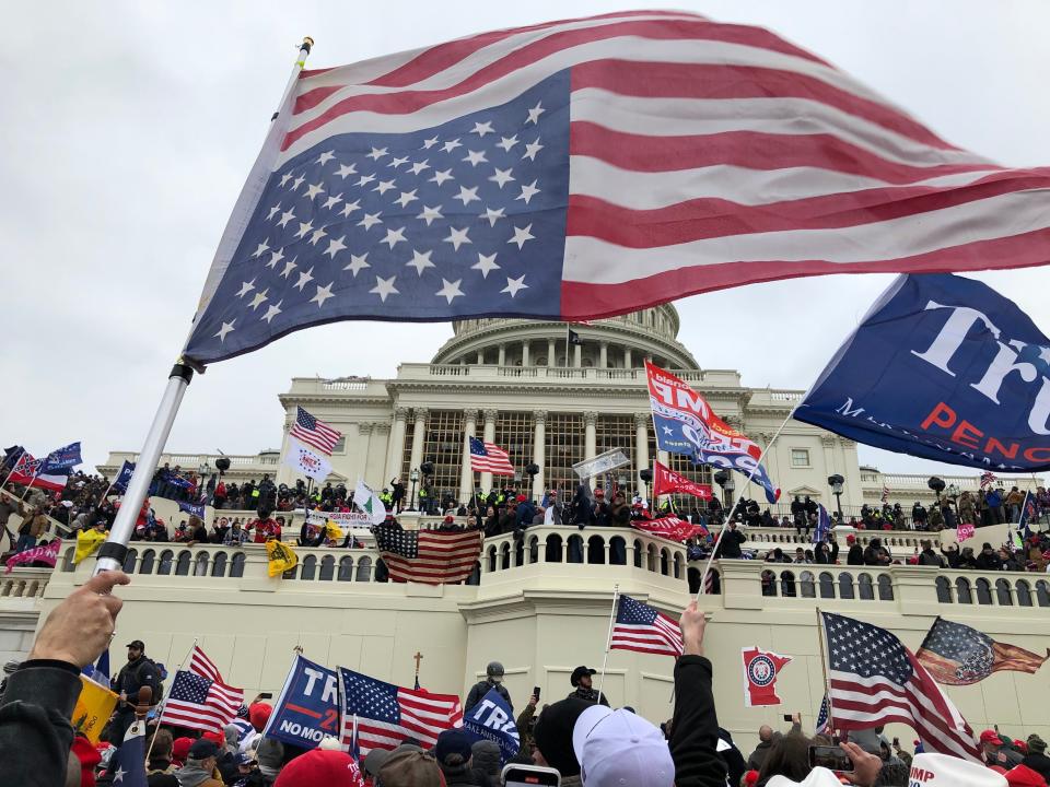 Rioters stand on the West front of the U.S. Capitol building to protest the official election of then-President-elect Joe Biden on Jan 6, 2020.