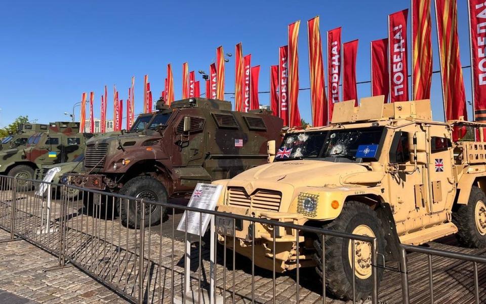 The bullet-riddled wreck of a British Husky (right) on display alongside other armoured vehicles