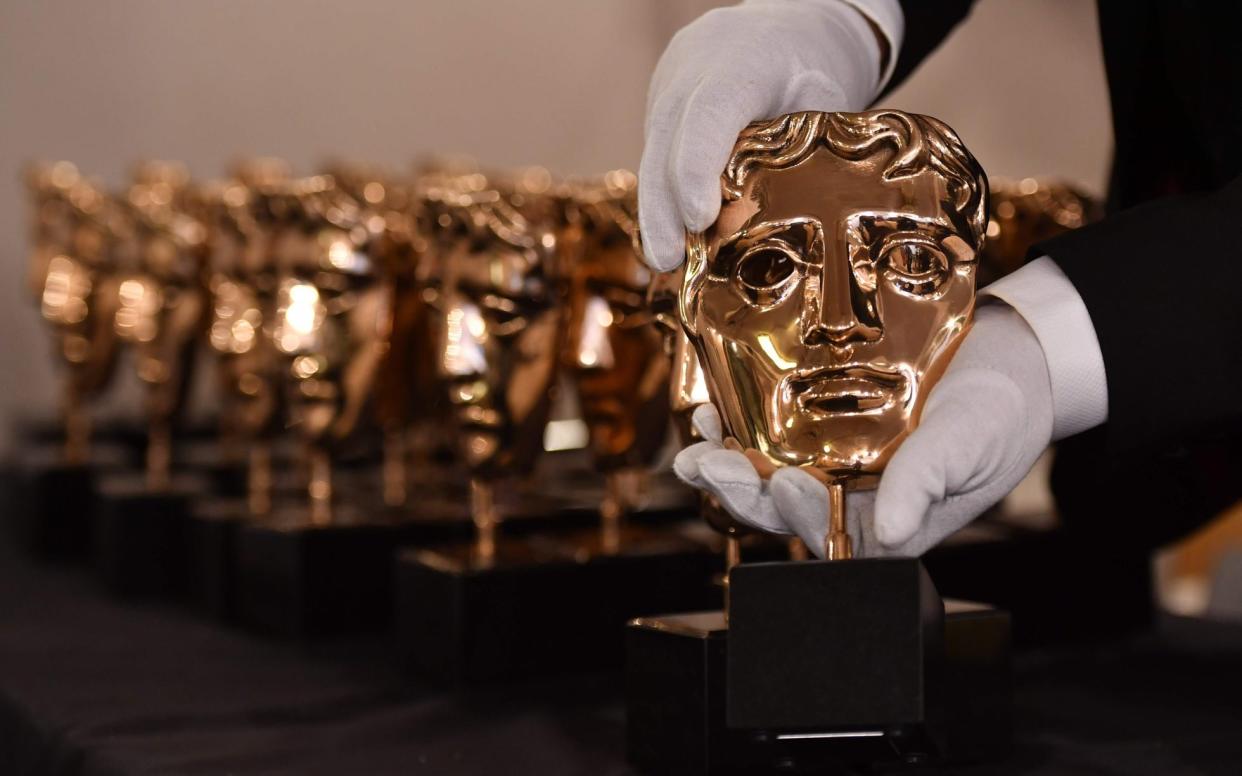 A member of staff polishes BAFTA awards - AFP or licensors