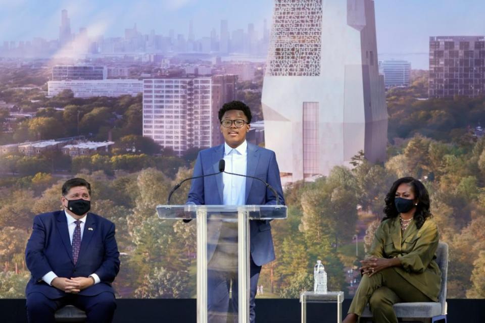 Chicago public schools student Trenton Banks speaks before introducing former President Barack Obama as Illinois Gov. J.B. Pritzker, left, and former first lady Michelle Obama listen during a groundbreaking ceremony for the Obama Presidential Center, Tuesday, Sept. 28, 2021, in Chicago. - Credit: AP