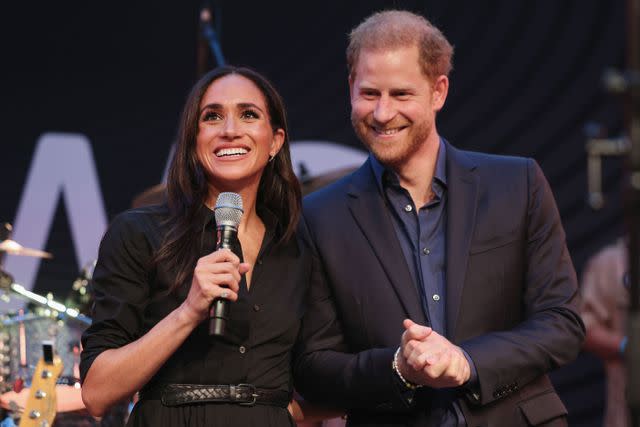 <p>Chris Jackson/Getty for the Invictus Games Foundation</p> Meghan Markle and Prince Harry speak on stage at the third day of the Invictus Games in Dusseldorf, Germany on Sept. 12, 2023.