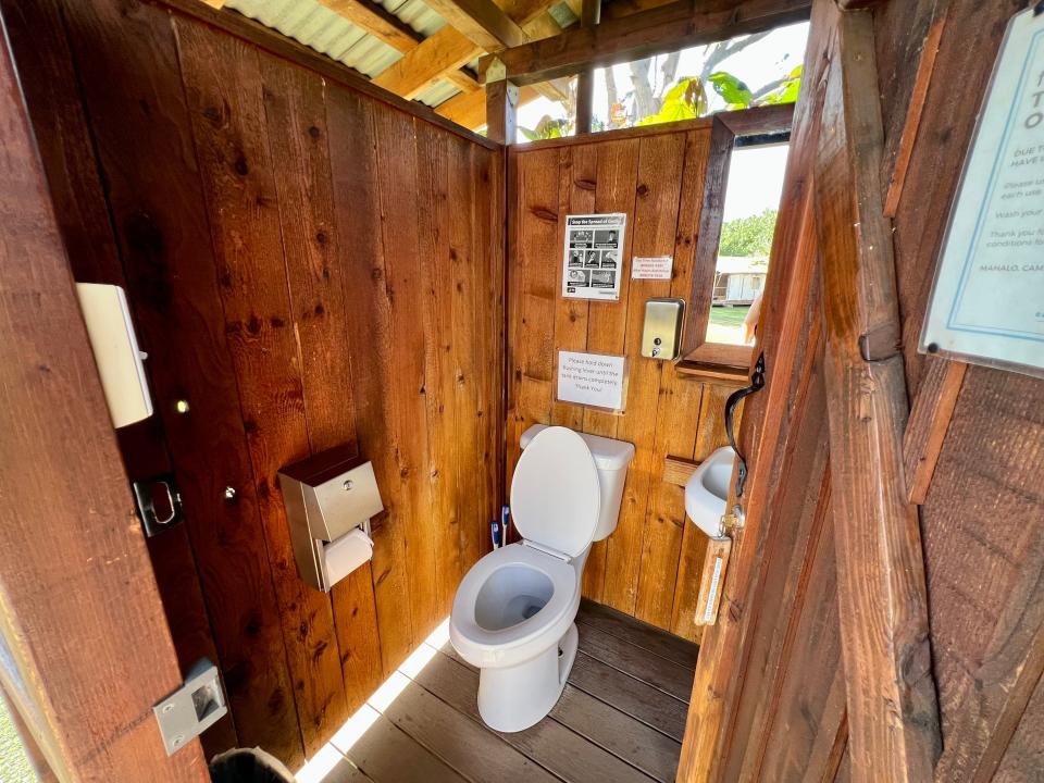 wood paneled bathroom with white toilet