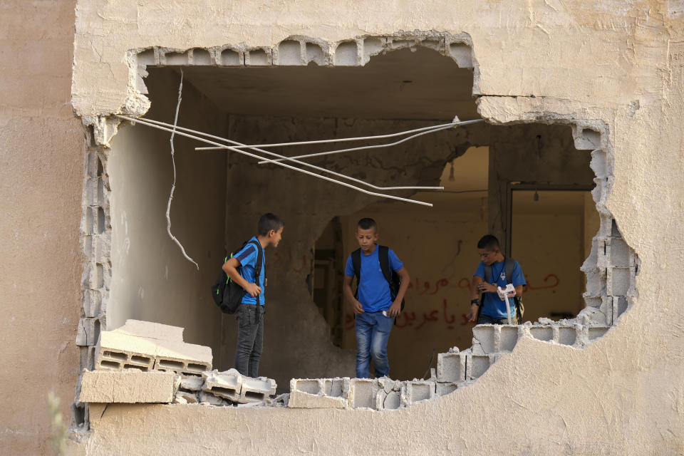 Locals look at the demolished house of Palestinian gunman Raed Hazem, who carried out a deadly attack in Tel Aviv in April, after it was destroyed by Israeli forces in the West Bank city of Jenin, Tuesday, Sept. 6, 2022. Hazem opened fire into a crowded bar in central Tel Aviv, killing three Israelis and wounding several others. Hours later he was killed in a shootout with Israeli security forces. (AP Photo/Majdi Mohammed)