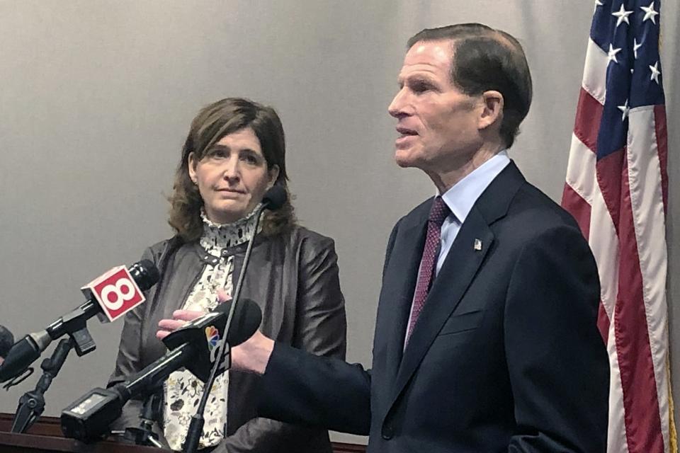 In this Dec. 27, 2019, photo, Karen Jarmoc, left, CEO of the Connecticut Coalition Against Domestic Violence, stands with U.S. Sen. Richard Blumenthal, D-Conn., at a news conference Hartford to announce federal funding to help domestic violence groups provide services to victims. Jarmoc said the case of Jennifer Dulos, the Connecticut mother of five who police believe was killed by her estranged husband, highlights the need to improve how family courts handle cases involving accusations of domestic violence. (AP Photo/Susan Haigh)