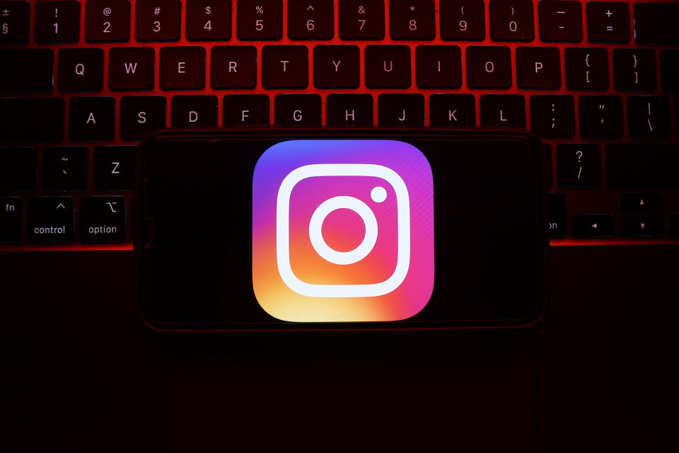 A laptop keyboard and Instagram icon displayed on a phone screen are seen in this illustration photo taken in Krakow, Poland on May 7, 2023. (Photo by Jakub Porzycki/NurPhoto via Getty Images)