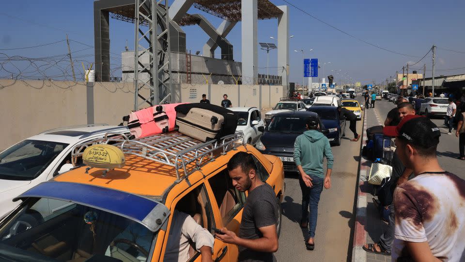 Palestinians with foreign passports arrive at the Rafah gate.  - Said Khatib/AFP/Getty Images