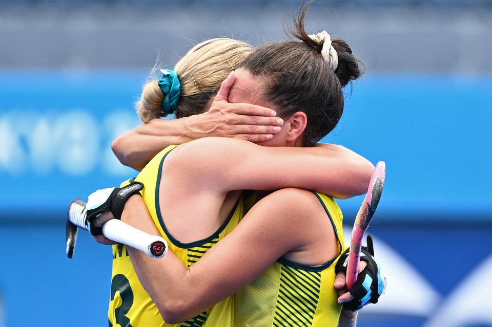 TOPSHOT - Australia's Edwina Bone (L) and Brooke Peris embrace after losing 1-0 to India in their women's quarter-final match of the Tokyo 2020 Olympic Games field hockey competition, at the Oi Hockey Stadium in Tokyo, on August 2, 2021. (Photo by CHARLY TRIBALLEAU / AFP) (Photo by CHARLY TRIBALLEAU/AFP via Getty Images)