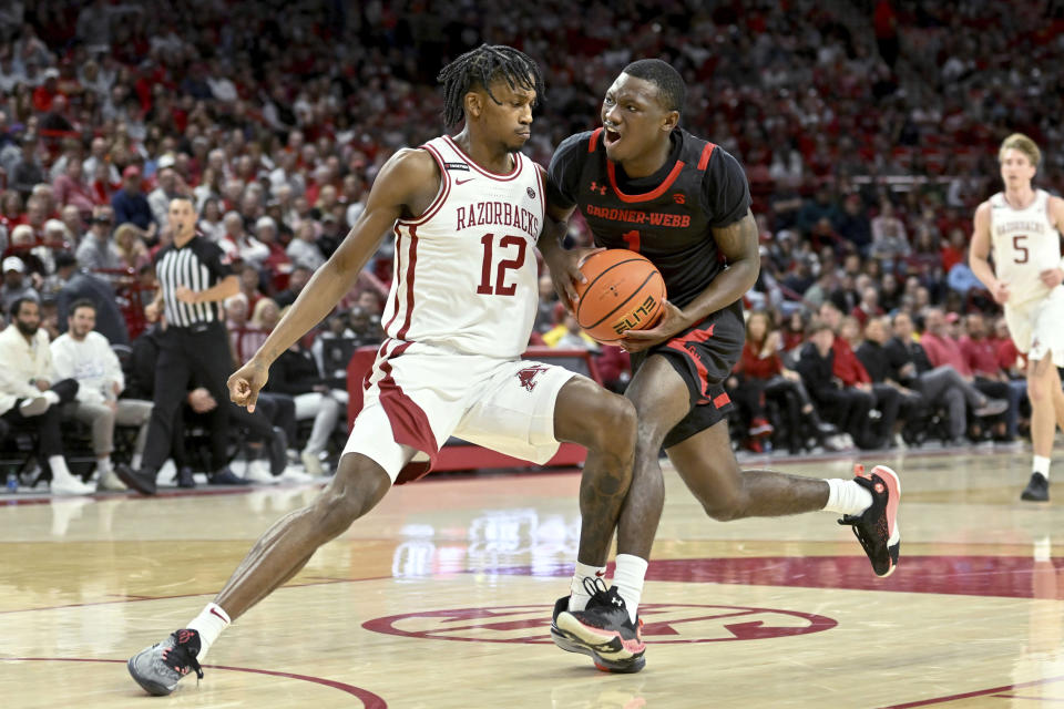 Gardner-Webb guard Julien Soumaoro (1) tries to drive past Arkansas guard Tramon Mark (12) during the first half of an NCAA college basketball game Friday, Nov. 10, 2023, in Fayetteville, Ark. (AP Photo/Michael Woods)