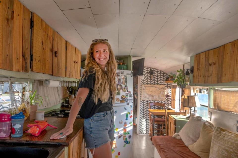 Emily Anderson shows off the interior of her renovated school bus, aka a “skoolie.” Her band, Arbour Season, was performing at the “Gutted” festival at Camp Branch this week. 