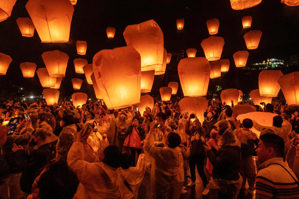 People celebrate the Pingxi Sky Lantern Festival by setting off hundreds of thousands of lanterns into the sky in New Taipei City, Taiwan, on Feb. 5, 2023.