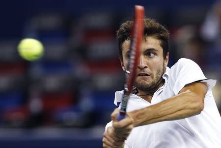 Gilles Simon of France returns a shot during his men's singles semi-final match against Feliciano Lopez of Spain at the Shanghai Masters tennis tournament in Shanghai October 11, 2014. REUTERS/Aly Song