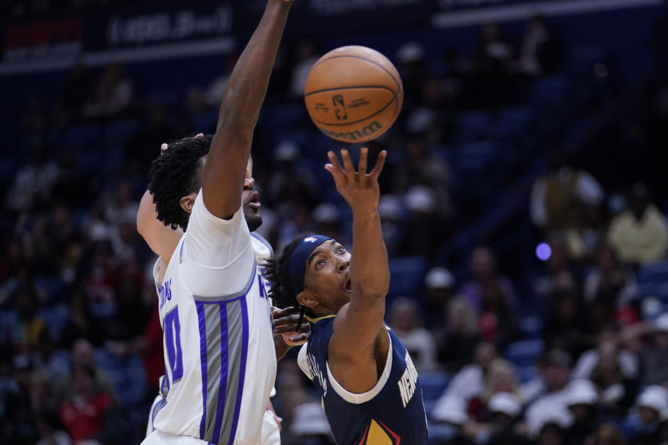 New Orleans Pelicans guard Devonte' Graham goes to the basket against Sacramento Kings center Damian Jones in the second half of an NBA basketball game in New Orleans, Wednesday, March 2, 2022. The Pelicans won 125-95. (AP Photo/Gerald Herbert)
