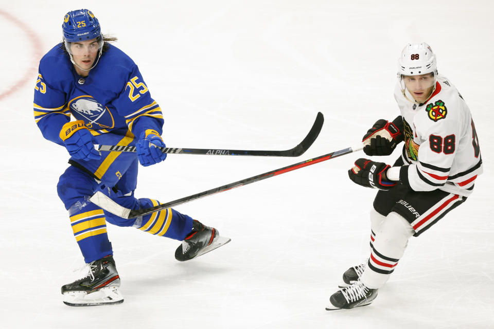 Buffalo Sabres defenseman Owen Power (25) passes the puck past Chicago Blackhawks right wing Patrick Kane (88)during the third period of an NHL hockey game, Saturday, Oct. 29, 2022, in Buffalo, N.Y. (AP Photo/Jeffrey T. Barnes)