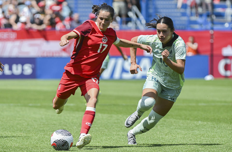 FILE - Canada's Jessie Fleming (17) breaks away from Mexico's Scarlett Camberos (10 during the first half of an international friendly soccer game in Montreal, Saturday, June 1, 2024. Canada opens the Olympic women's soccer tournament with New Zealand in Group A. Colombia and host France round out the group. (Graham Hughes/The Canadian Press via AP, File)