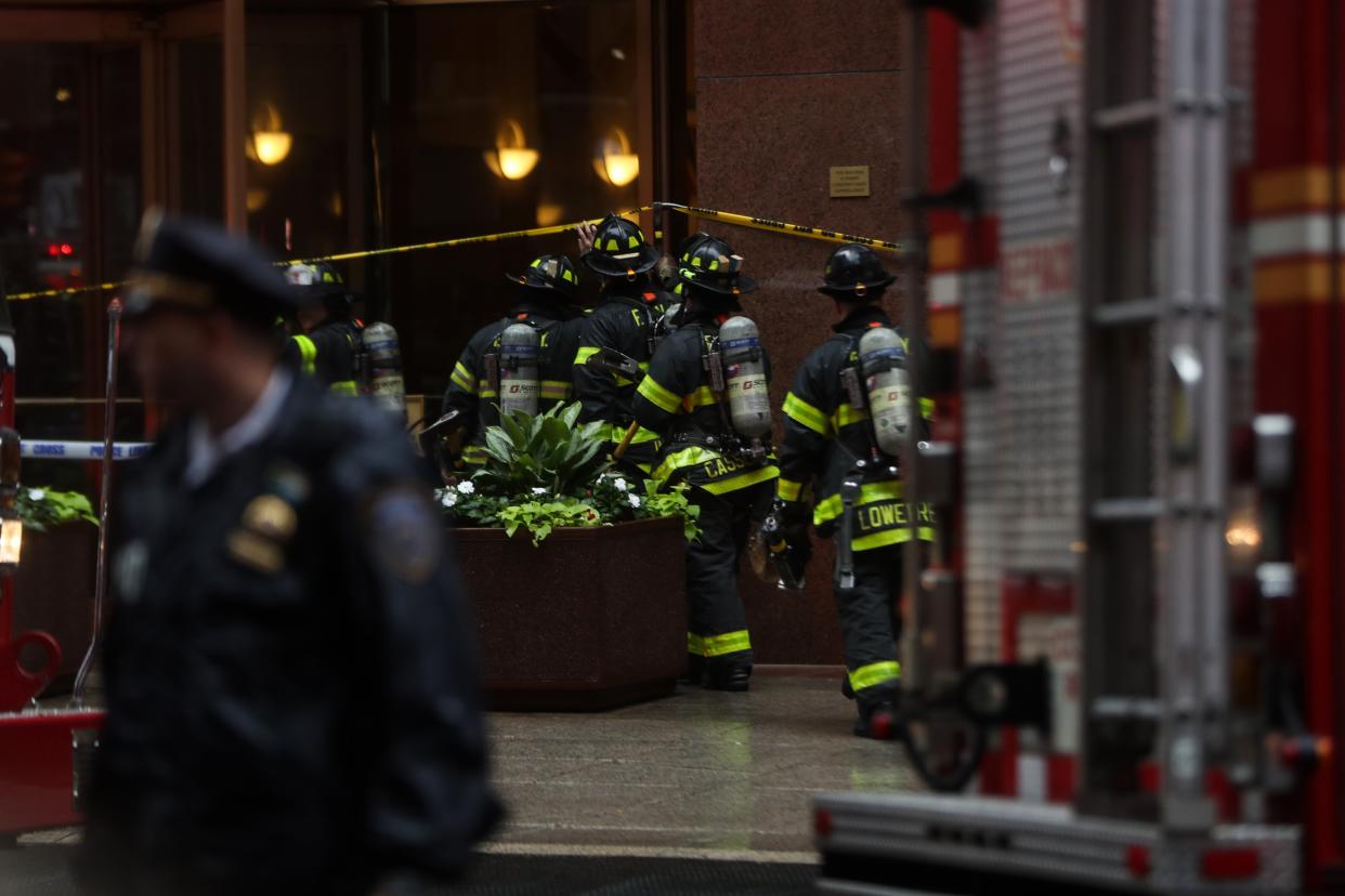 Firemen seen entering the AXA Euitable Center in Manhattan after a helicopter crashed on the building's roof. (PHOTO: Getty Images)