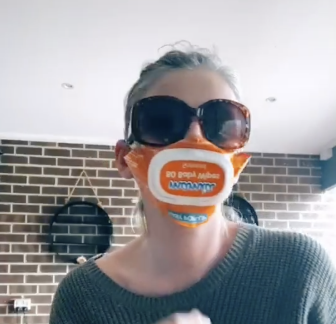 Emily Rumbold tied the sides of an old wet wipe packet around her ears and positioned the lid over her mouth. Source: TikTok/mumdadof7