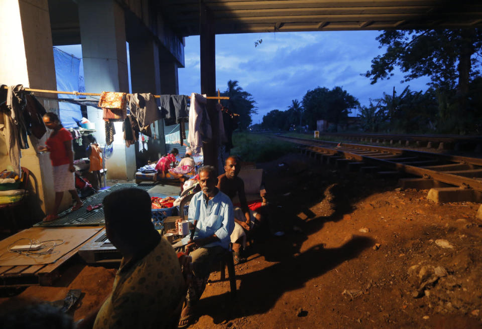 Sri Lankans displaced by the flood take refuge in a temporary shelter under an overpass next to a railway track in Colombo, May 17, 2016. (AP Photo/Eranga Jayawardena)