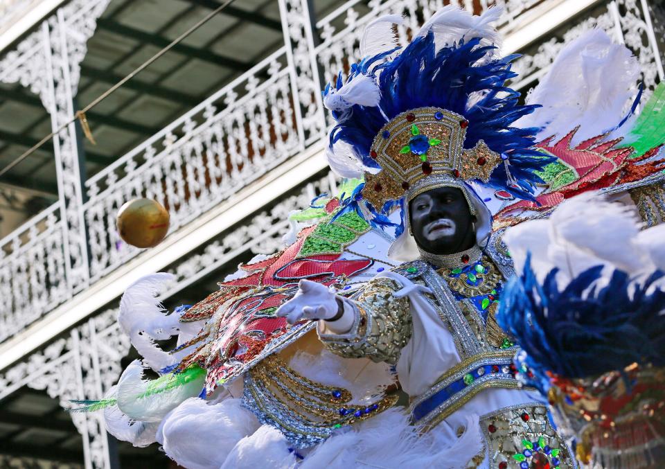 A member of the Zulu Social Aid and Pleasure Club throws a coconut during Mardi Gras day on Feb. 9, 2016 in New Orleans. 