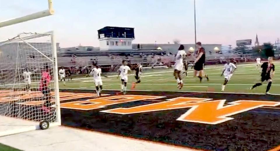 Cathedral Prep's Cameron Dunbar (black uniform) leaps in the air to head a shot past Erie High goalkeeper Bonane Taabu during the second half of Tuesday's boys soccer match between the Ramblers and Royals at Dollinger Field. Dunbar's goal provided Prep some insurance en route to its 3-1 Region 5 victory.