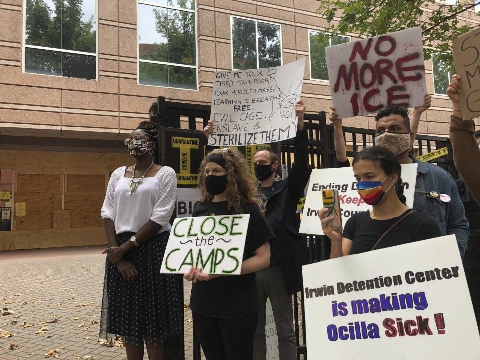 FILE - In this Tuesday, Sept. 15, 2020, file photo, Dawn Wooten, left, a nurse at Irwin County Detention Center in Ocilla, Georgia, speaks at a news conference in Atlanta protesting conditions at the immigration jail. An Associated Press review of medical records for four detained immigrant women at the detention center and interviews with lawyers have revealed growing allegations that a gynecologist performed surgeries that the women never sought or didn’t fully understand. (AP Photo/Jeff Amy, File)